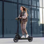 A_young_woman_rides_an_electric_scooter_through_city_streets_showcasing_a_stylish_and_convenient_daily_commuting_experience