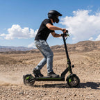 A_helmeted_young_man_is_shown_riding_an_off_road_electric_scooter_outdoors_demonstrating_its_powerful_performance_and_all_terrain_riding_capabilities