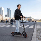 A_young_person_zips_through_city_streets_on_an_electric_scooter_stylish_lightweight_and_enjoying_a_free_easy_commute